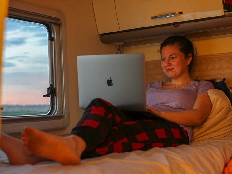 gilr on laptop in RV