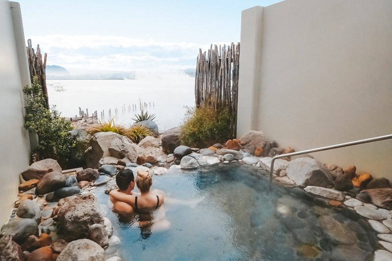 Couple in a hot spring during their New Zealand campervan honeymoon-1