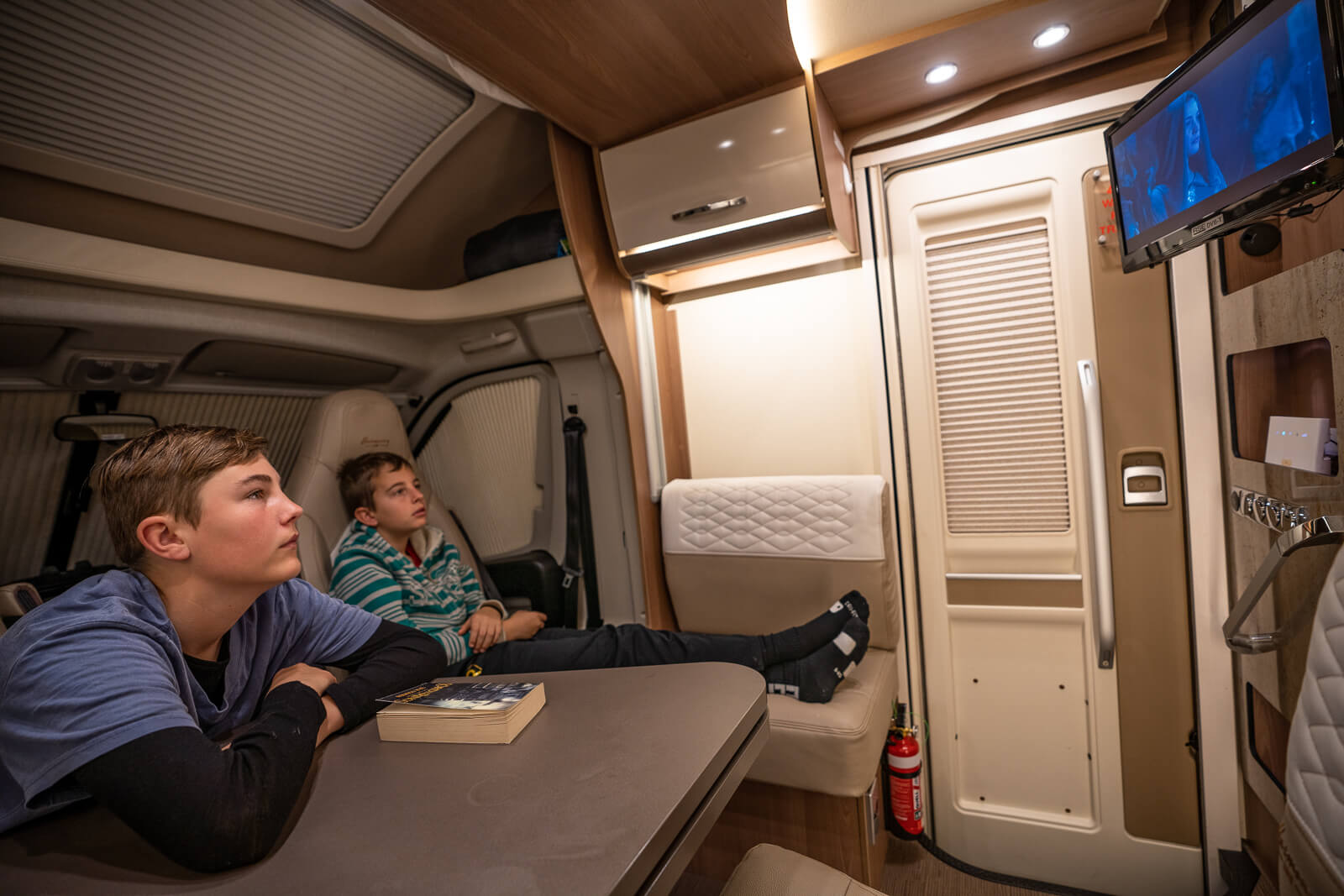 tweens enjoying dvd and onboard wifi of a Wilderness Motorhome