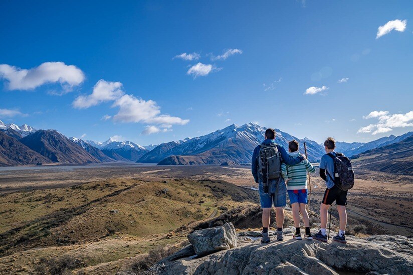 family hiking up Mount Sunday in New Zealand