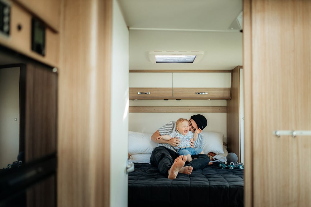 baby and dad on bed in motorhome