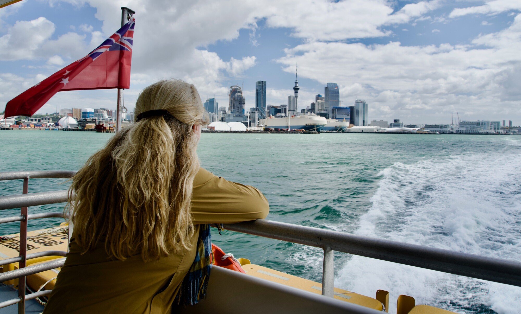 woman looking out to Auckland city from a ferry