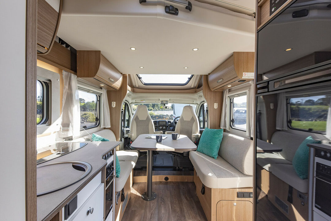 Dining area of a luxury motorhome with cab seats swivelled around