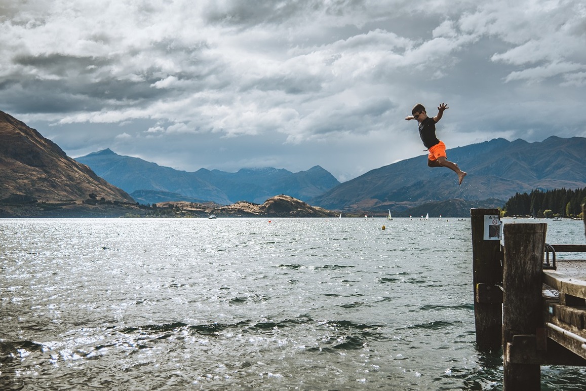 Child jumping over Lake Wanaka