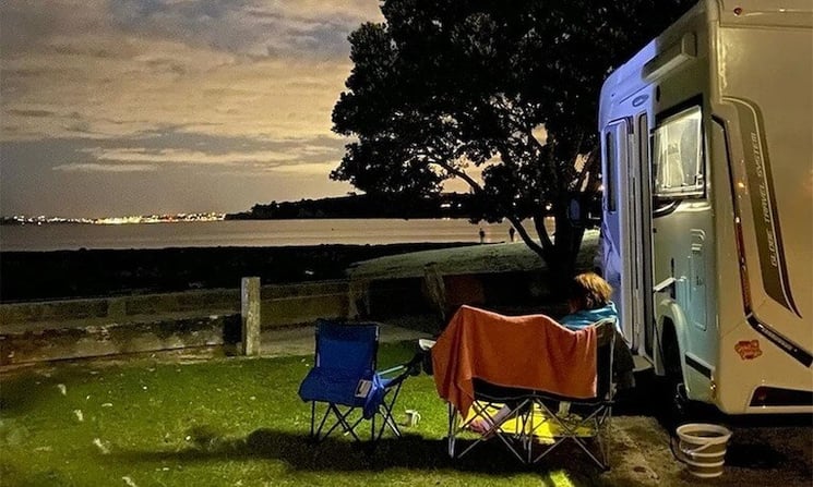 Takapuna Holiday Park at night by a motorhome