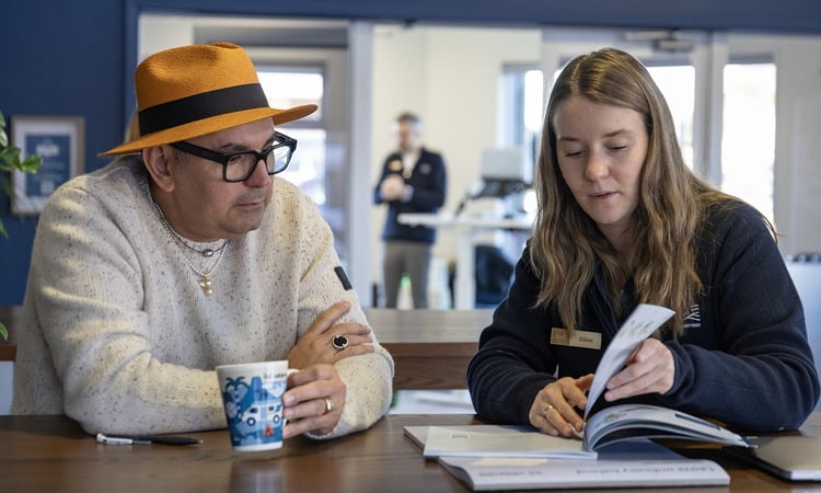 Paulo and Elaine going over paperwork CHCH ADS
