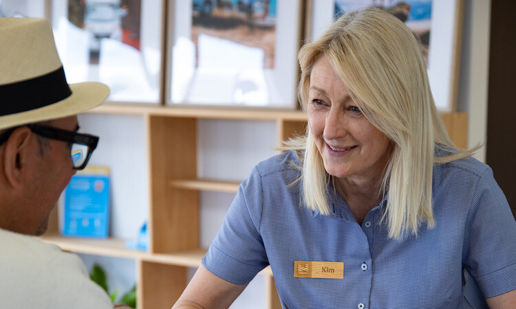 A Wilderness Motorhome team member talking to traveller