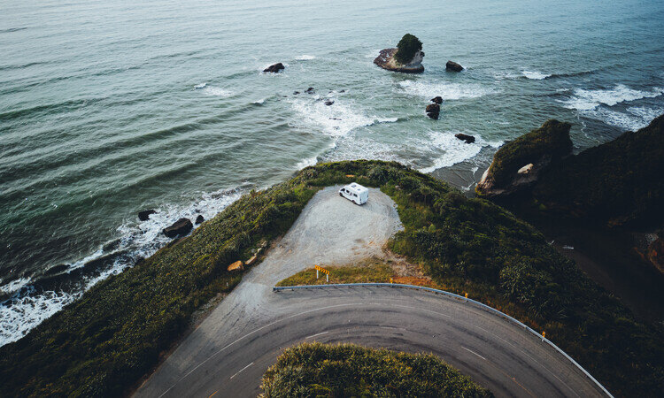 A Wilderness motorhome stopping at a lookout at a coastal route in New Zealand