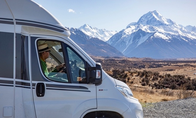 A man driving a Wilderness motorhome towards Aoraki Mount Cook