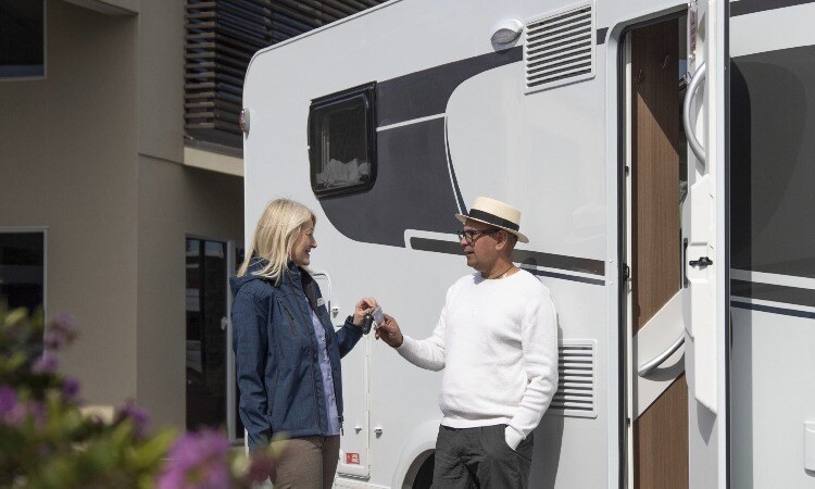 Rental operator handing motorhome keys to a guest