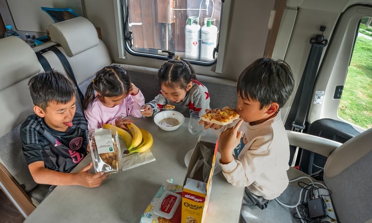 Kids eating food in motorhome