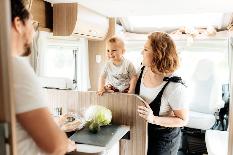 A family with infant enjoying their time in a motorhome