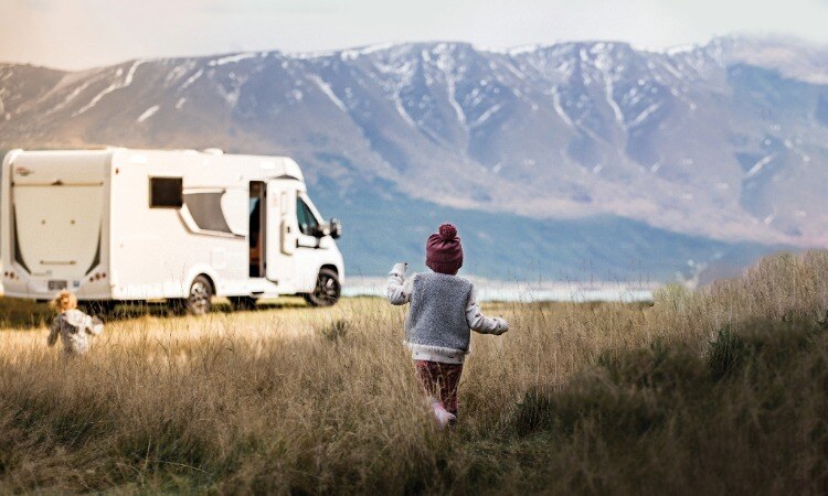 Child running towards a motorhome