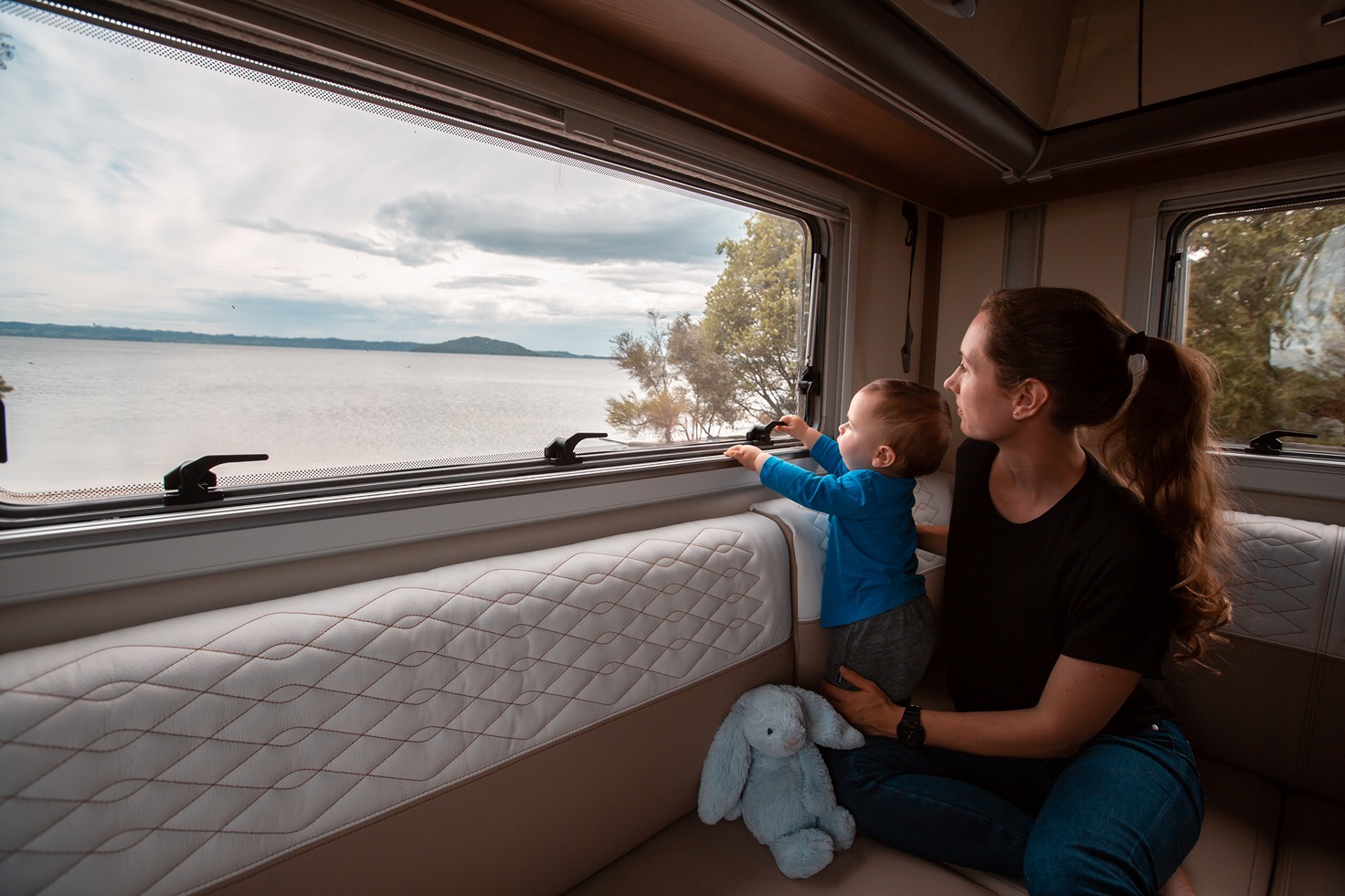Mom and child looking out of a motorhome window