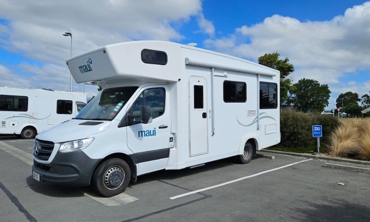 A Maui motorhome parked up at a parking site