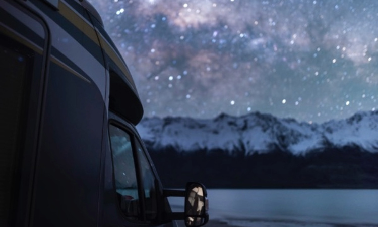 A motorhome with stars in the background