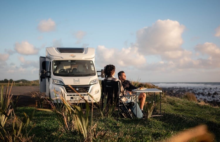 Freedom camping Cape Egmont with camping chairs by beach