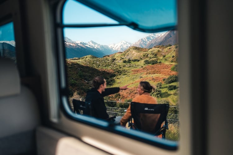 Couple sitting on camping chairs looking at Mt Cook