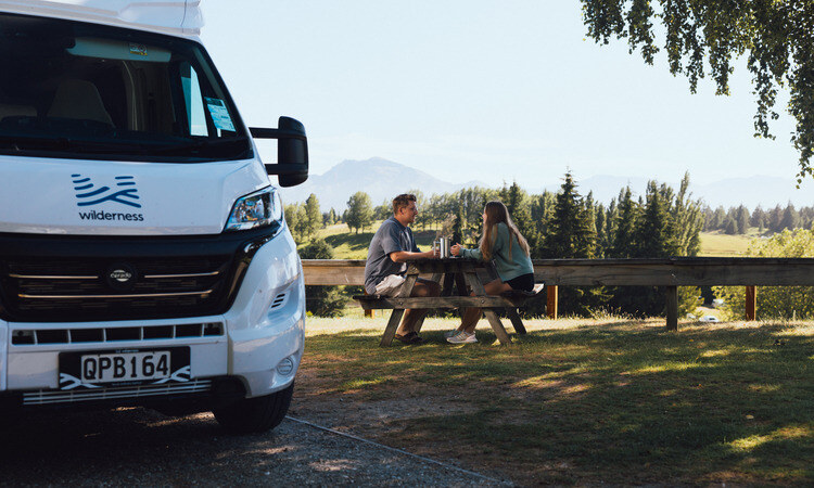 A couple enjoying their time in the outdoors outside of their motorhome