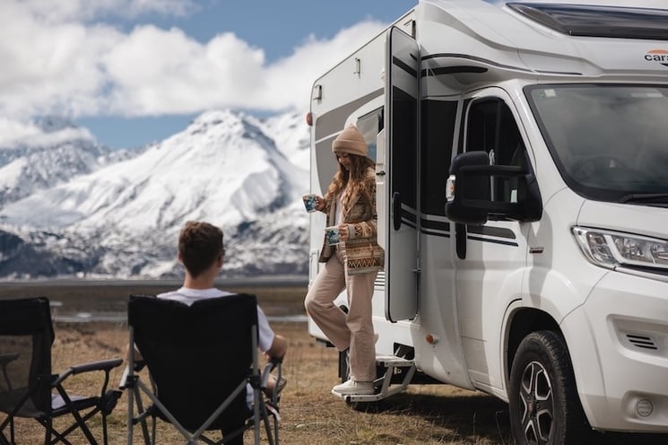 A couple freedom camping by Lake Pukaki with a cuppa