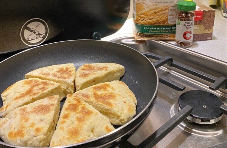 Cumin & chilli girdle scones cooking in pan