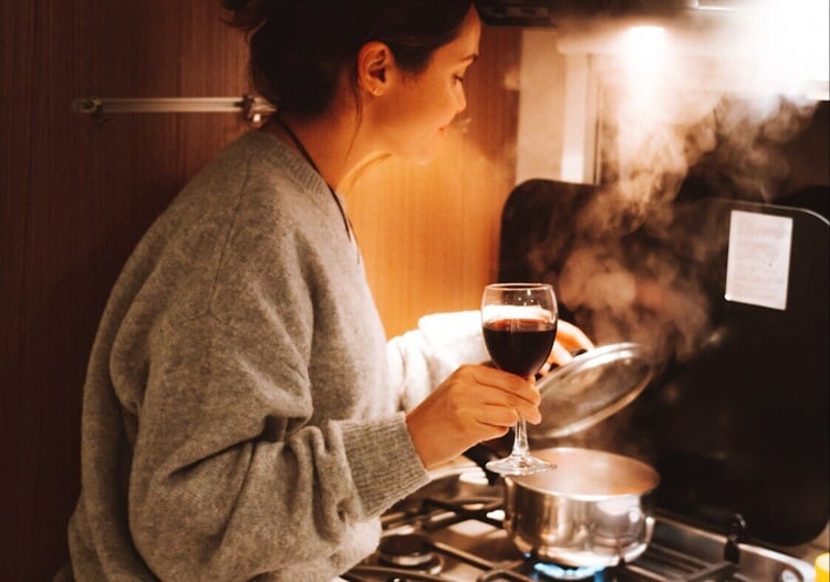 Cooking in kitchen with glass of wine