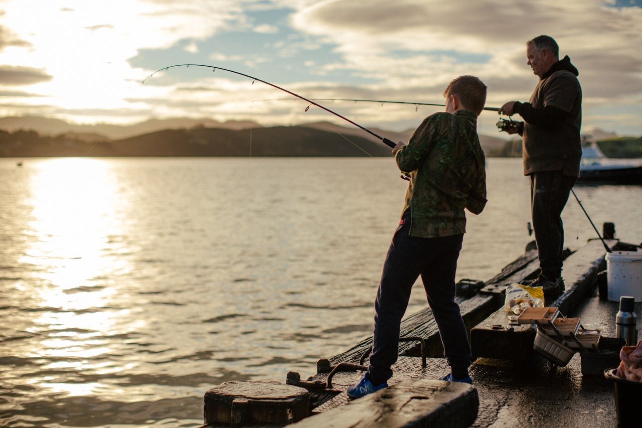 Dad and son fishing together