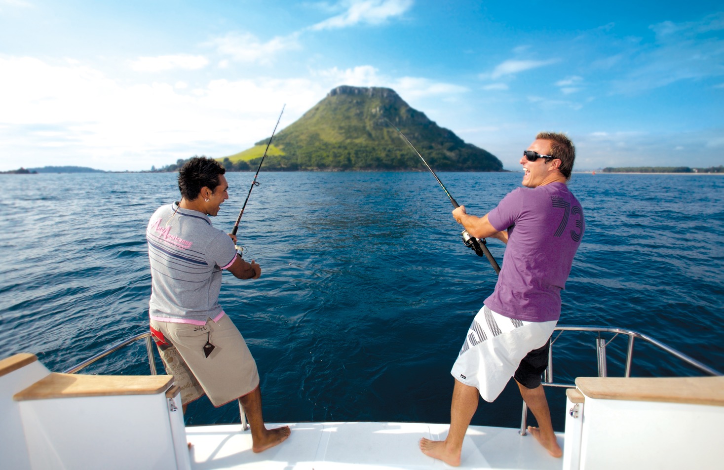 Friends having fun fishing on a boat