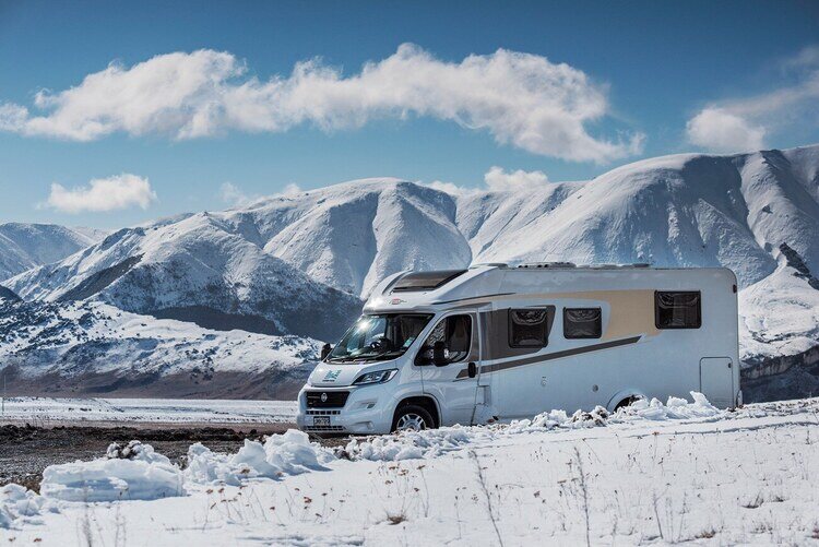 Motorhome parked in mountains snowy conditions