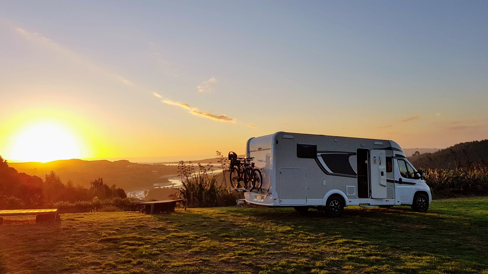 Bikes behind a Wilderness Motorhome with a sunset in the background