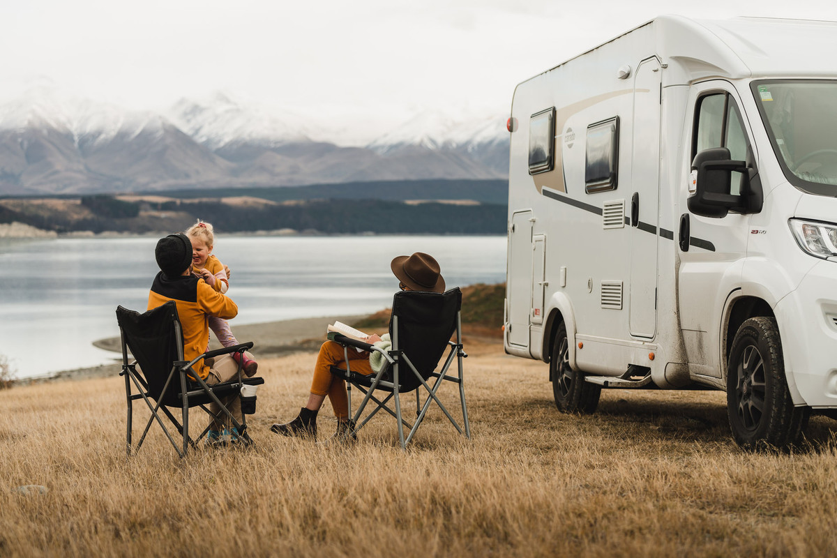 A family camping infront of a lake