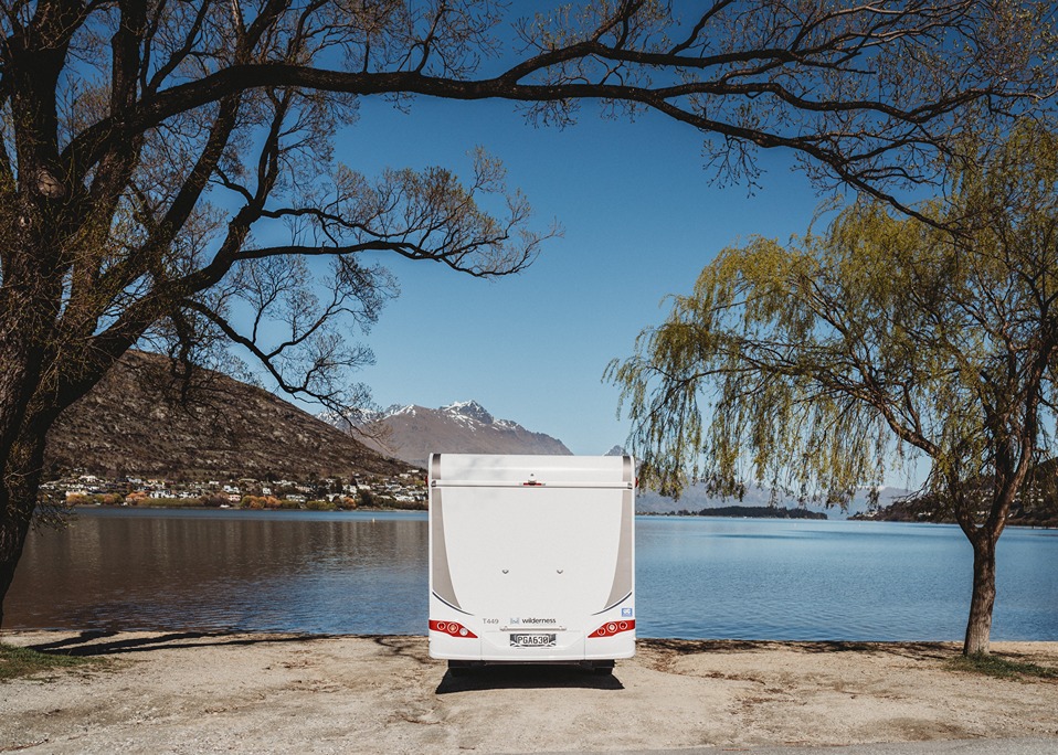 A motorhome parked up in front of a lake