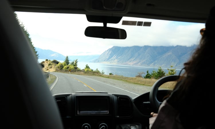 Driving view from cab with lake and mountains