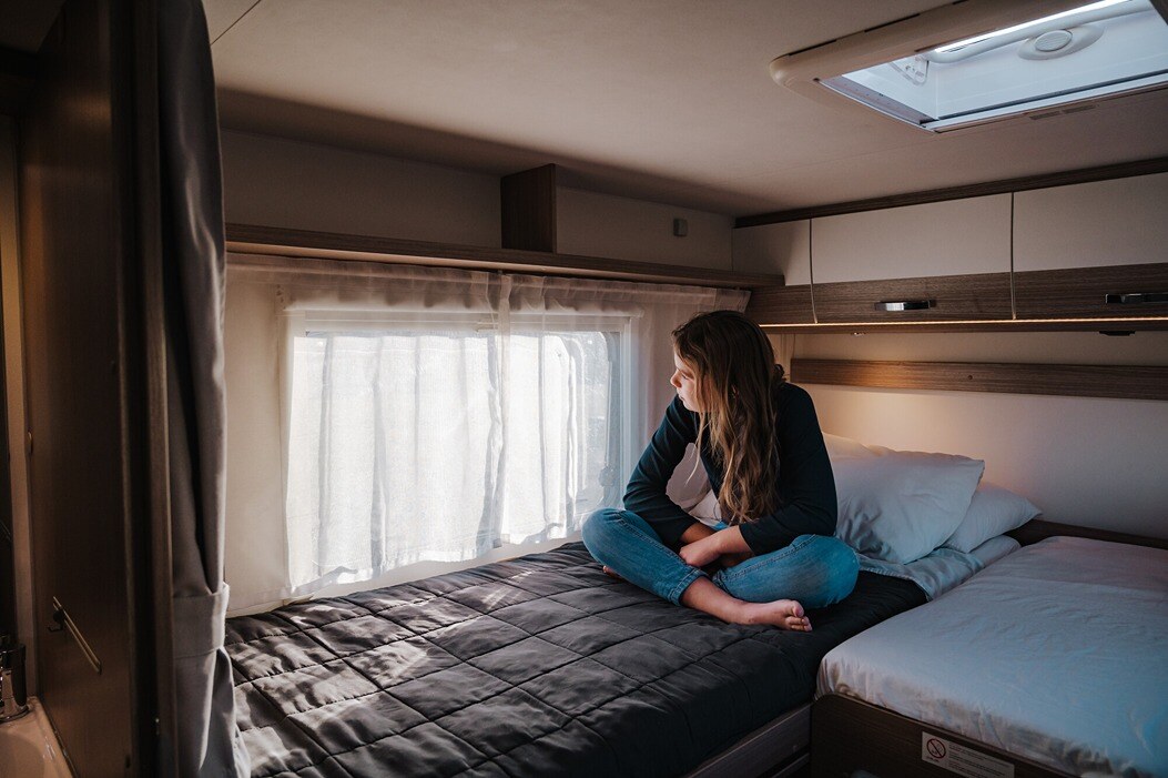 A person resting on the King/Twin for 4 Wilderness Motorhome Twin Bed Layout