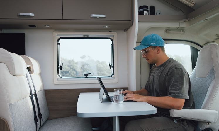Sitting at laptop in motorhome