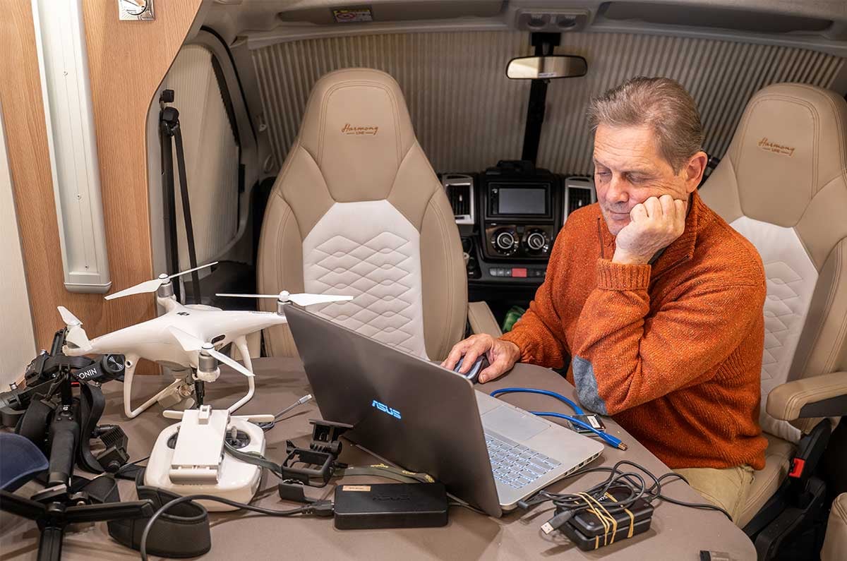 Mike Brown working with laptop and devices in a Wilderness The Suite motorhome