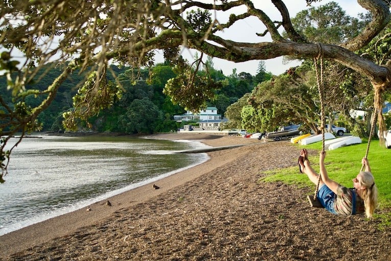 Lady at Russell near Paihia on a beach swing