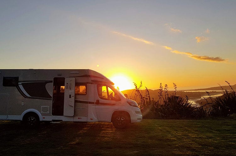 Motorhome-parked-on-a-field-sunset