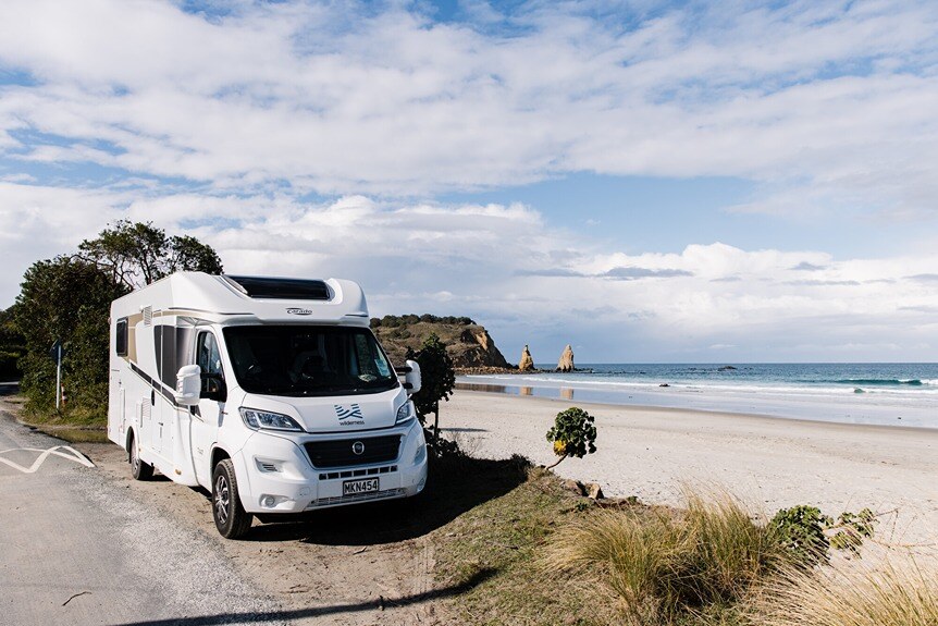 Tina Duncan eating breakfast in front of Wilderness motorhome