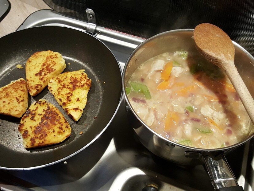 Refried girdle scones with white chicken chilli cooking in Wilderness motorhome