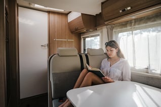 Reading a guidebook inside a motorhome