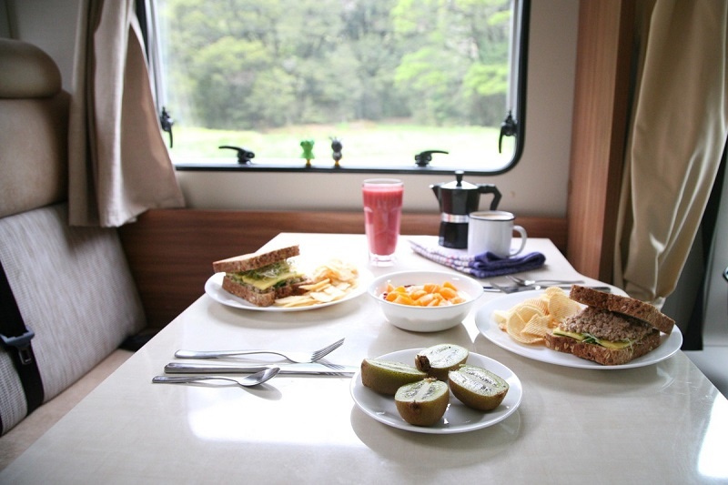 Sandwiches and fruit on the dining table of your Wilderness motorhome