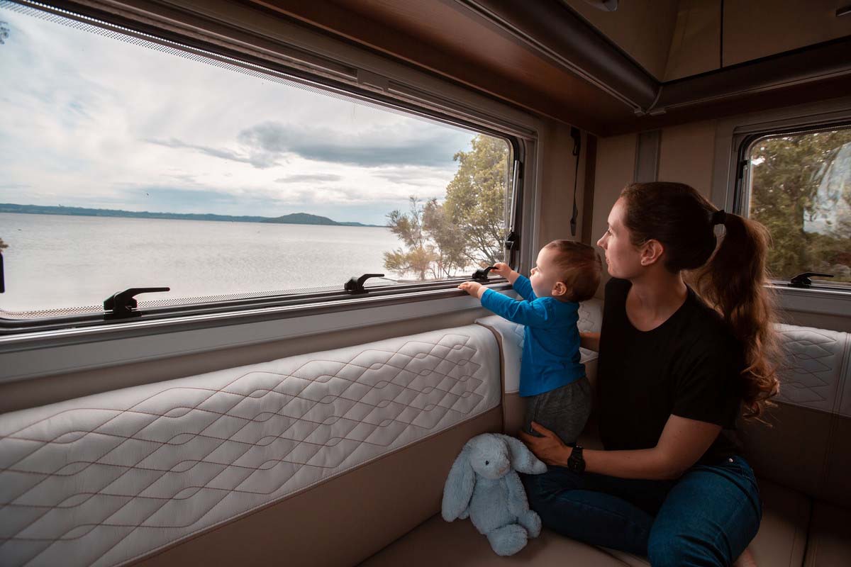 Baby looking outside of motorhome window