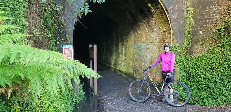 Woman biking the Hauraki Rail Trail New Zealand