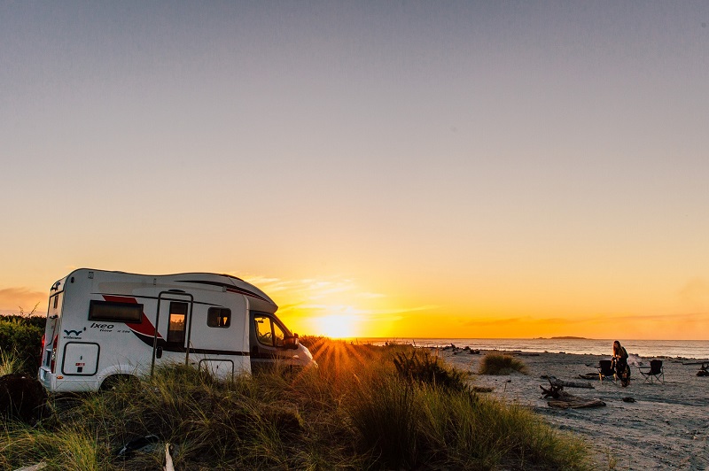 Freedom camping by the beach with a Wilderness campervan