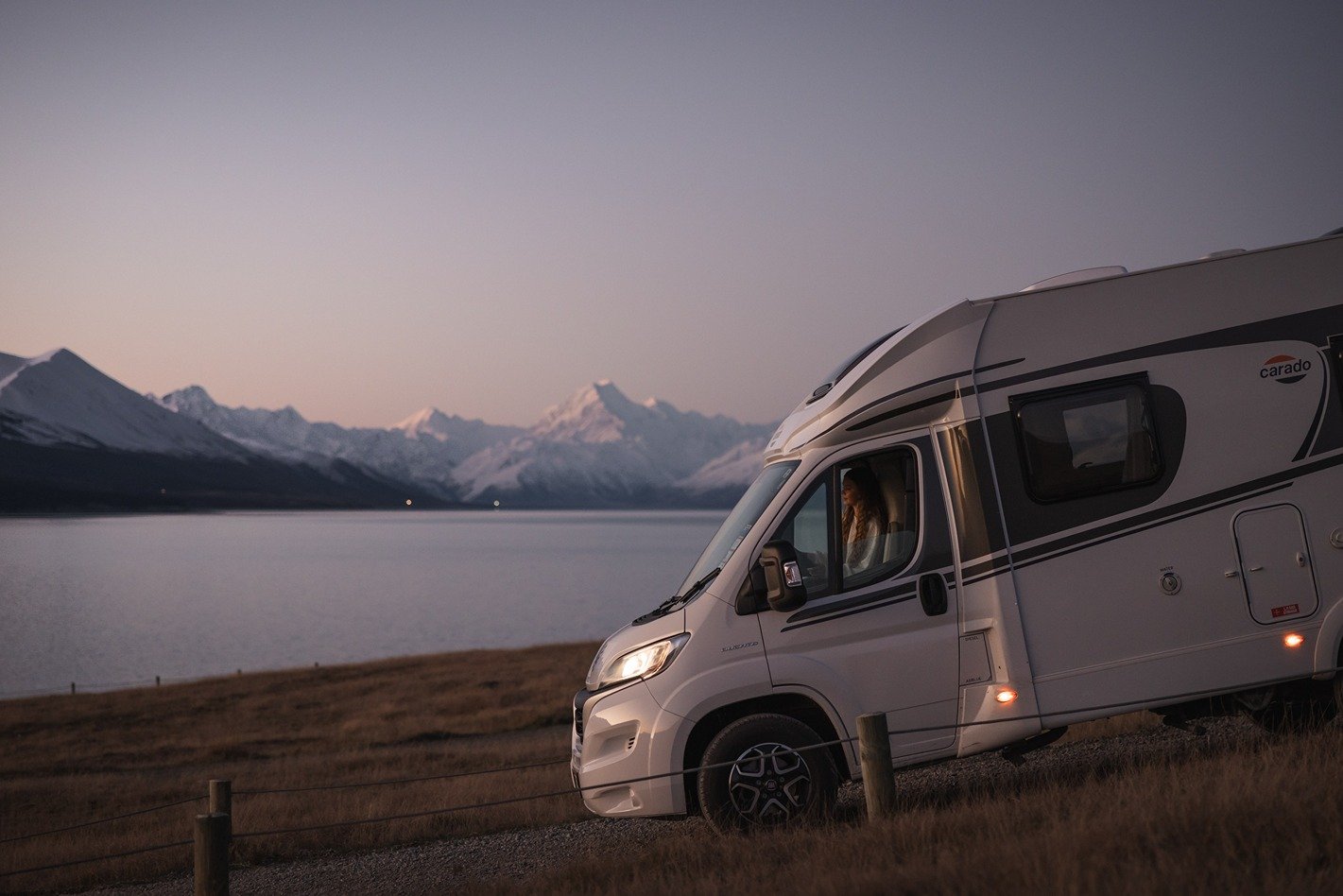 Traveller driving the motorhome with mountain background