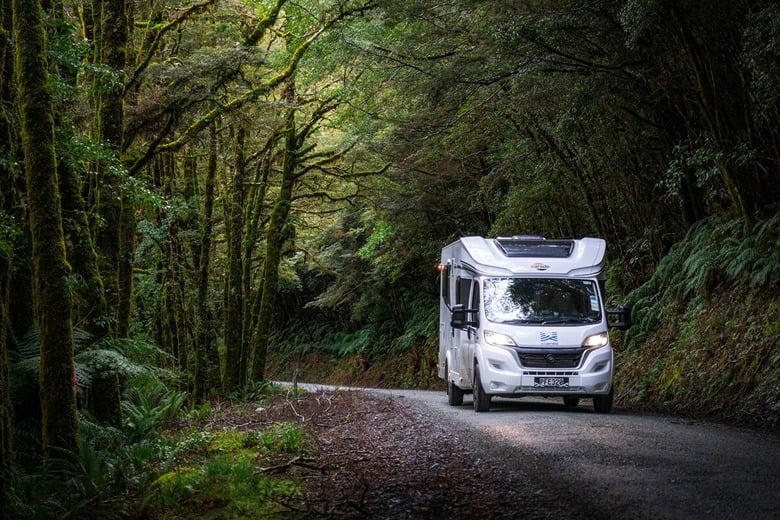 Motorhome being driven outdoor on gravel road
