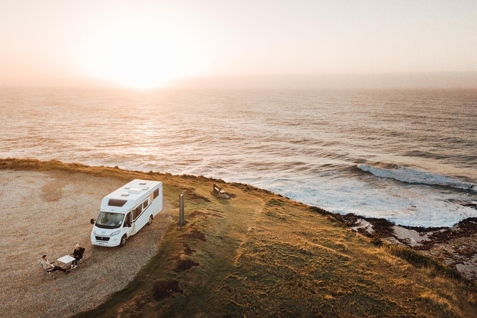 Couple relaxing outside of motorhome