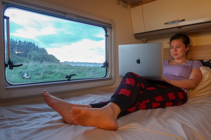Woman using internet in a Wilderness motorhome